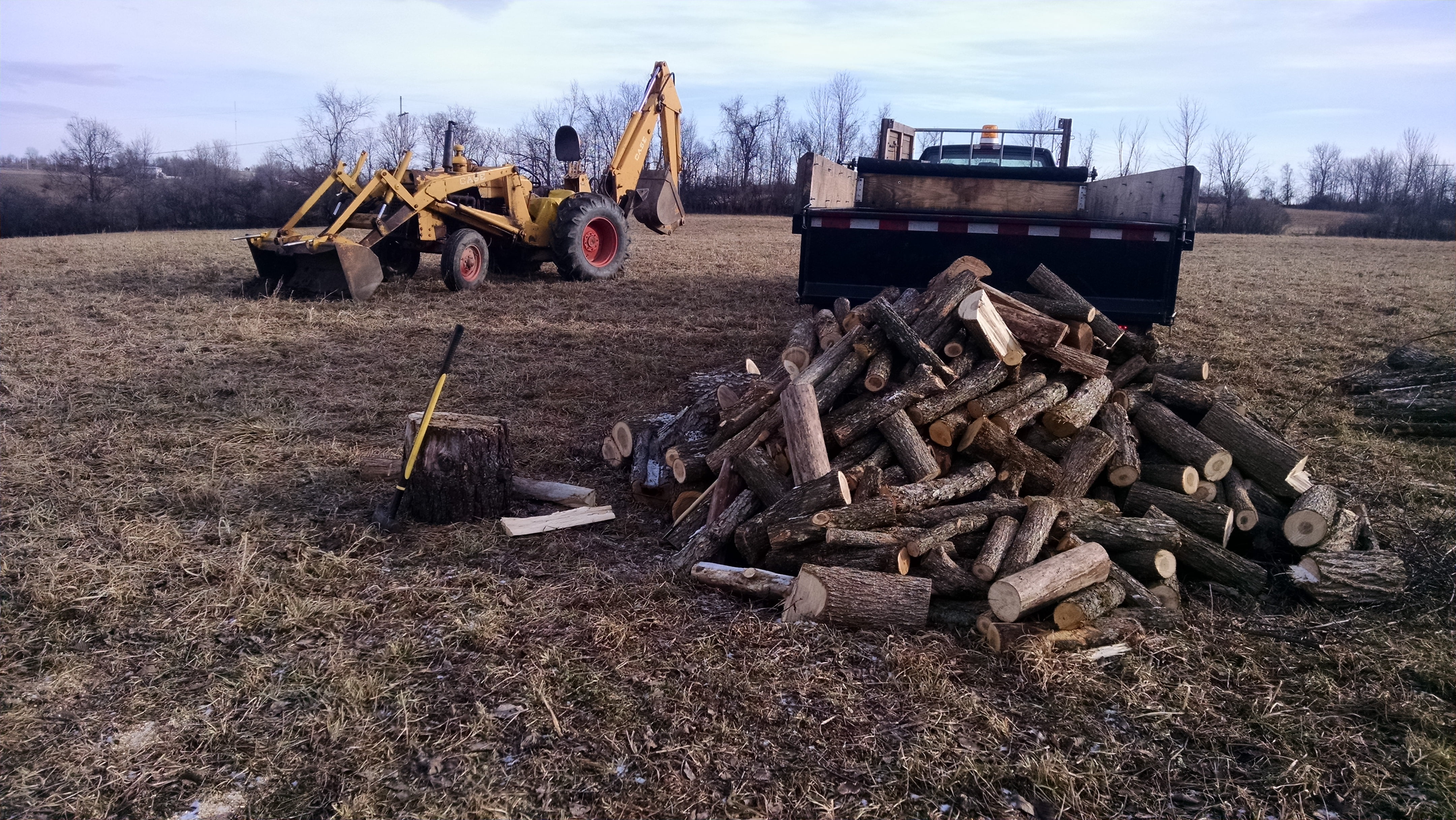 We use the backhoe to drag heavier logs out of the ravine.  The four wheeler works well on flat ground, but it doesn't have enough oomph to do the uphill pull.