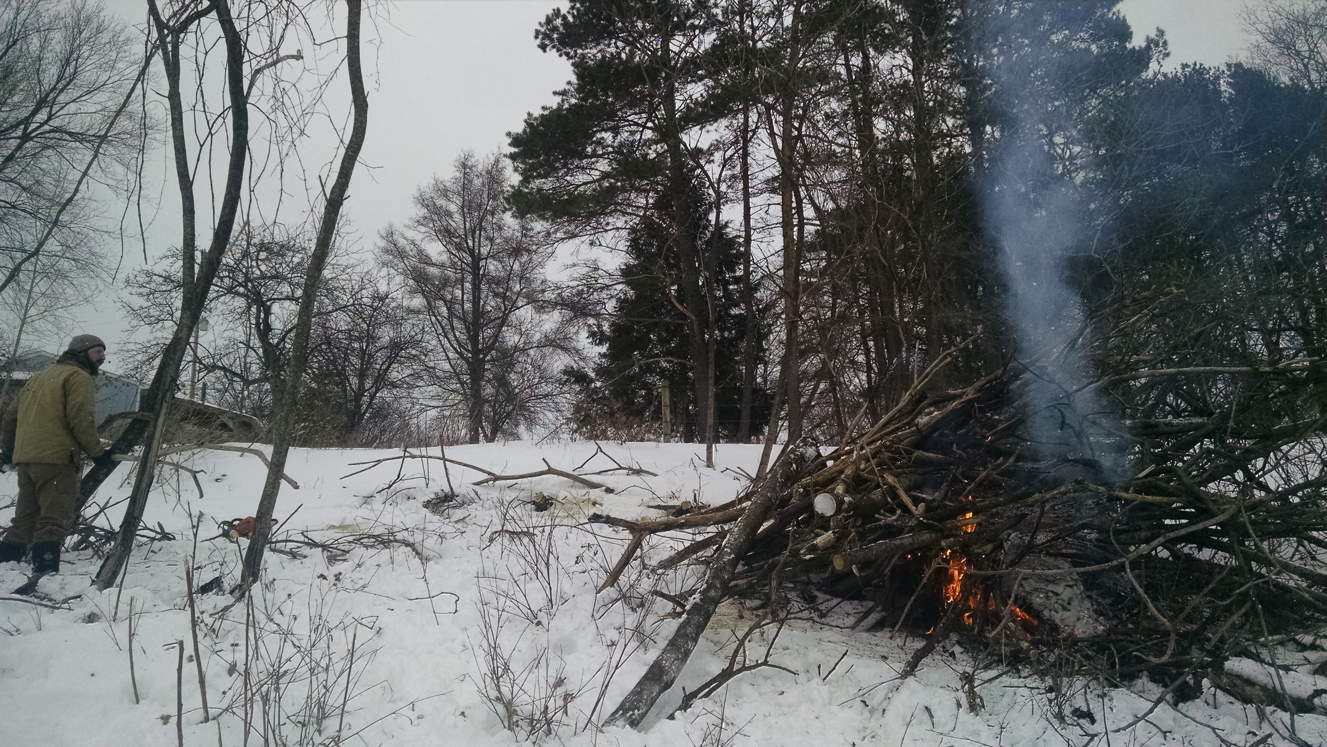 Starting the burn.  AJ and Allie helped get the fire started by packing a dense core of dry branches and cardboard scraps.  Harry didn't help per se; he spent his time figuring out how much other stuff he could catch on fire.