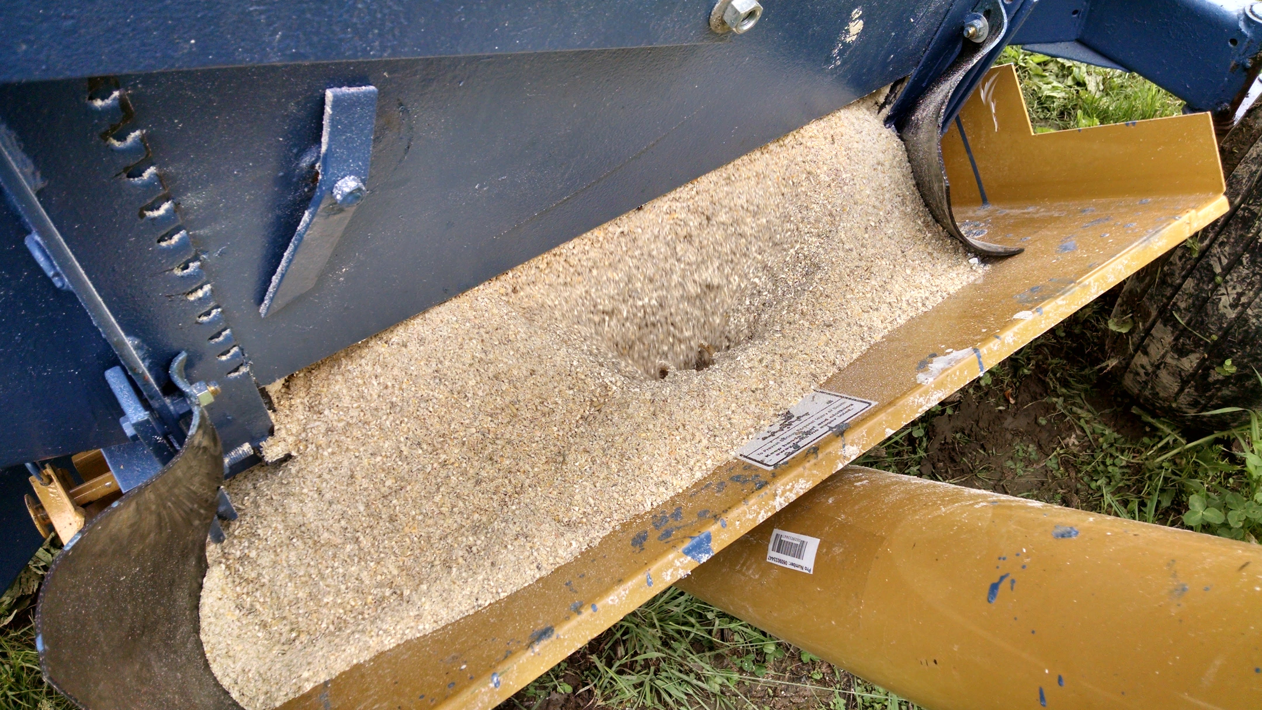 Grain flowing out of the wagon into the auger hopper.  I might add a plywood extension to the hopper to prevent overflow problems