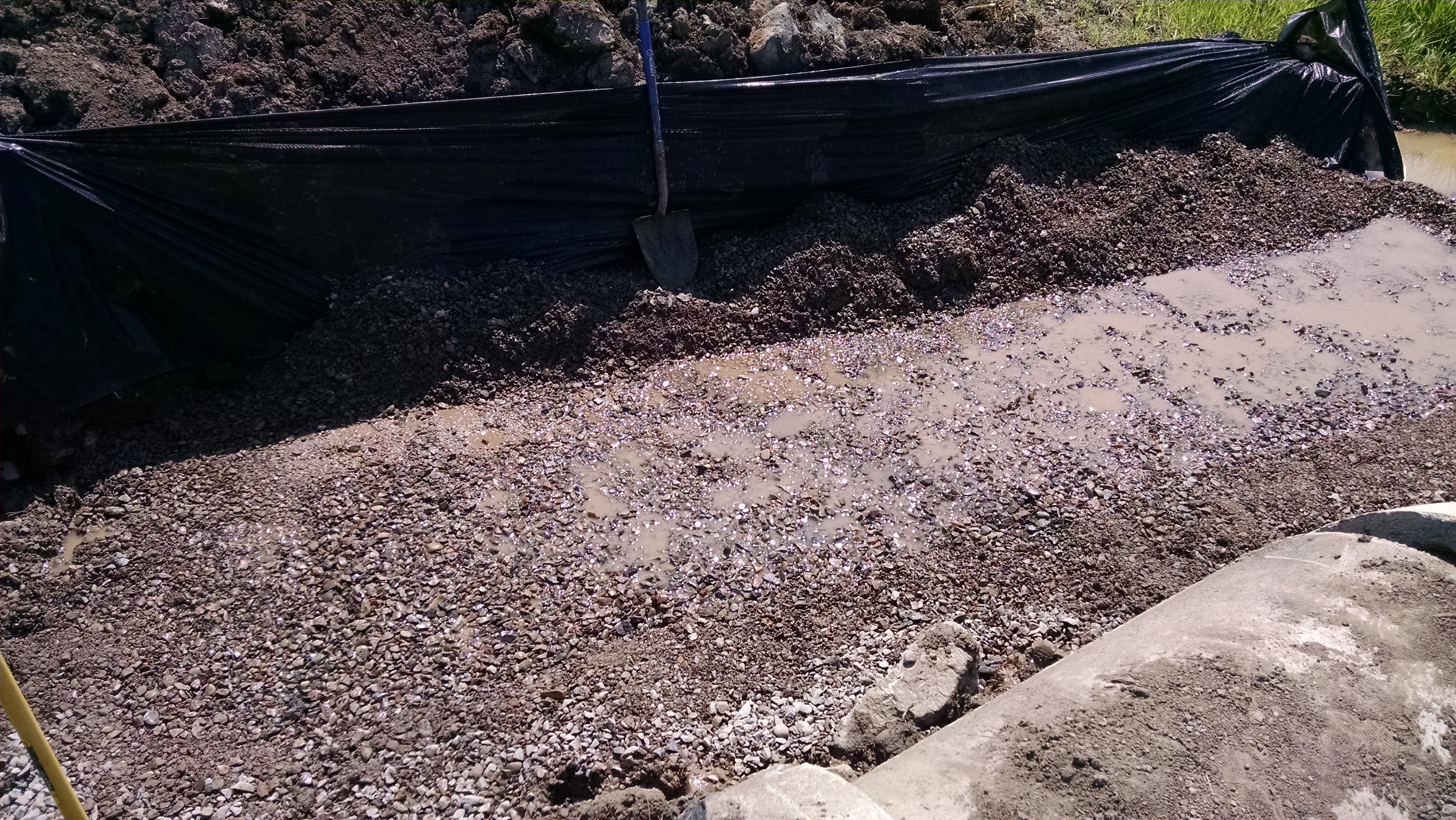 We over-excavated and backfilled with gravel under the abutments.  We found that it was easier to pump the water level down just to the point where the excavation was flooded, thus giving ourselves and easy method to judge when the footings were level.