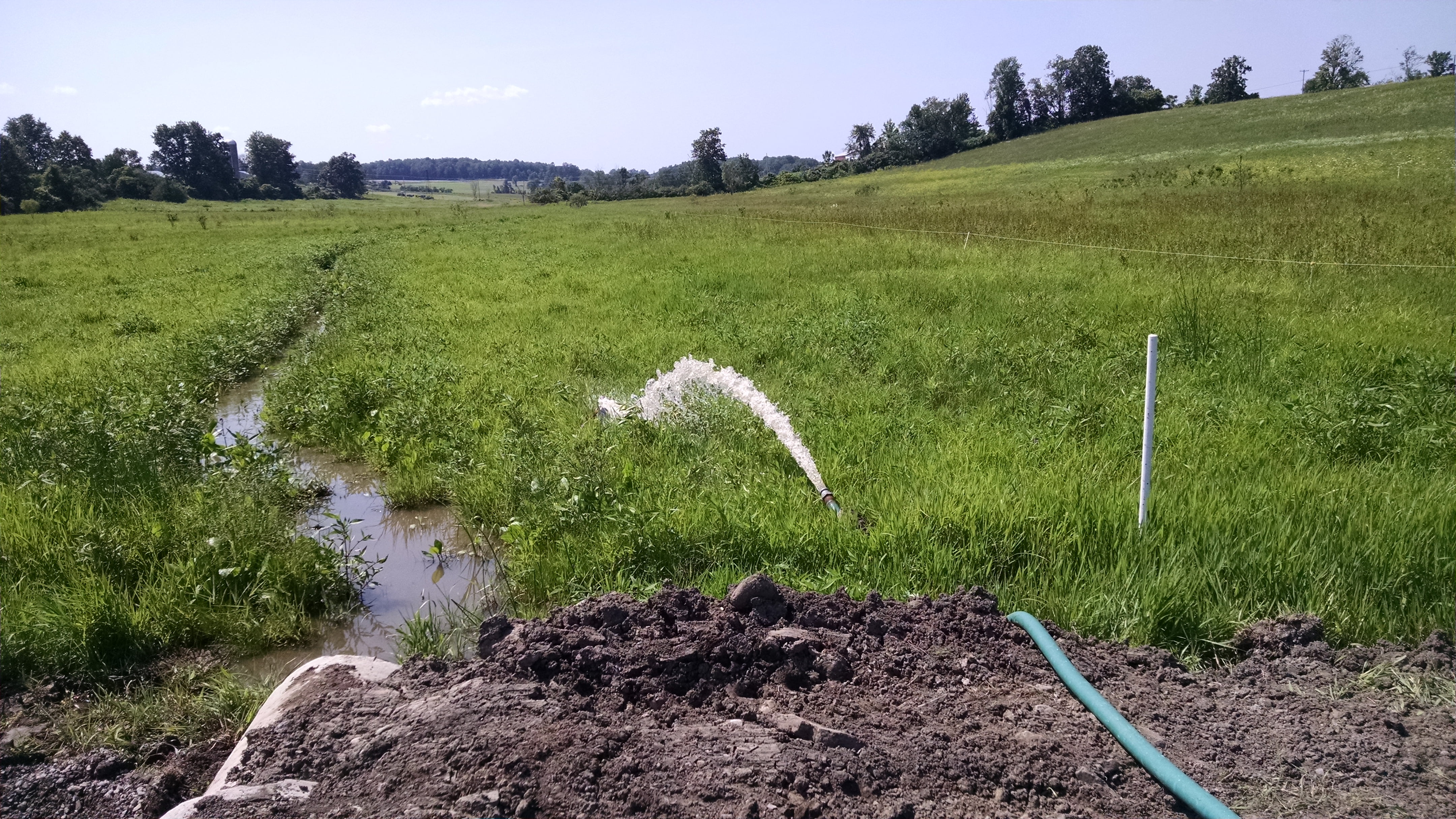 First we had to pump some of the water out of the small settling pond on the upstream side.