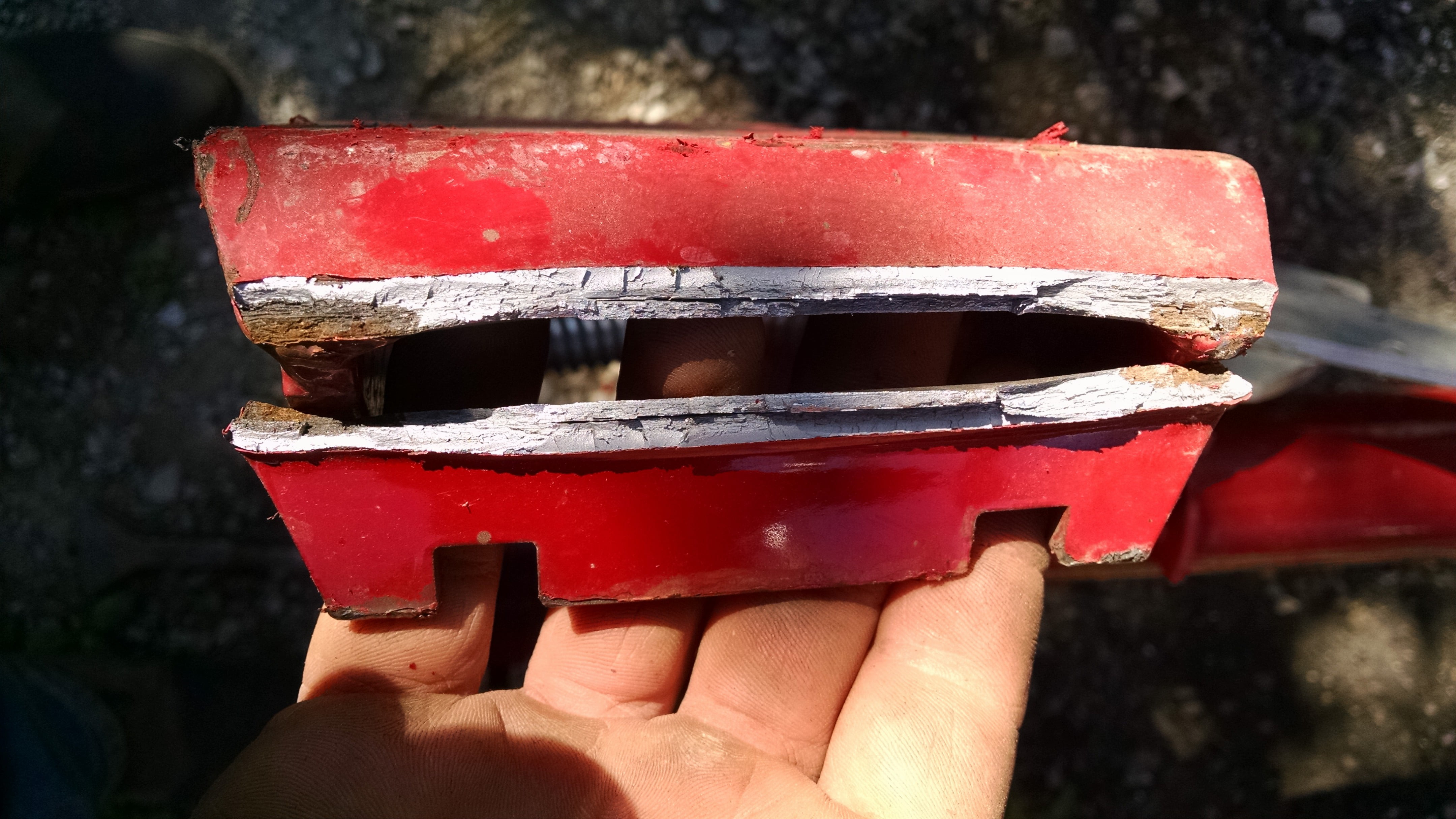 The quick attach tab on the loader cracked and bent.  Rust at each end indicates that this problem started earlier, probably as early as I started using this tractor.