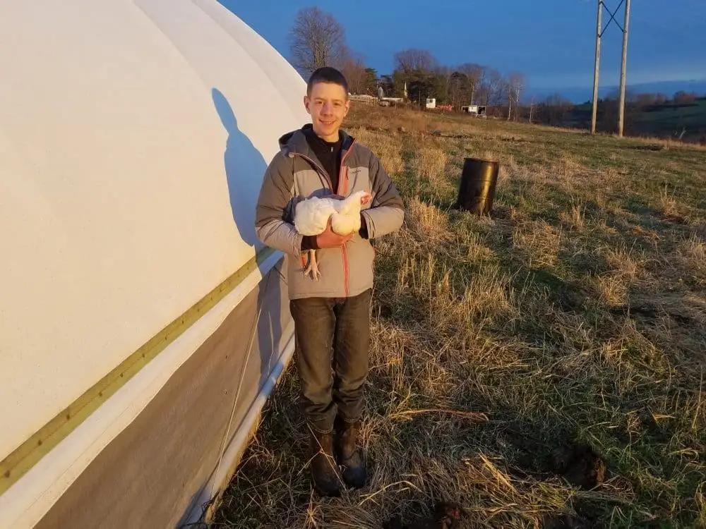 Standing next to one of the WDF pasture shelters for chickens.