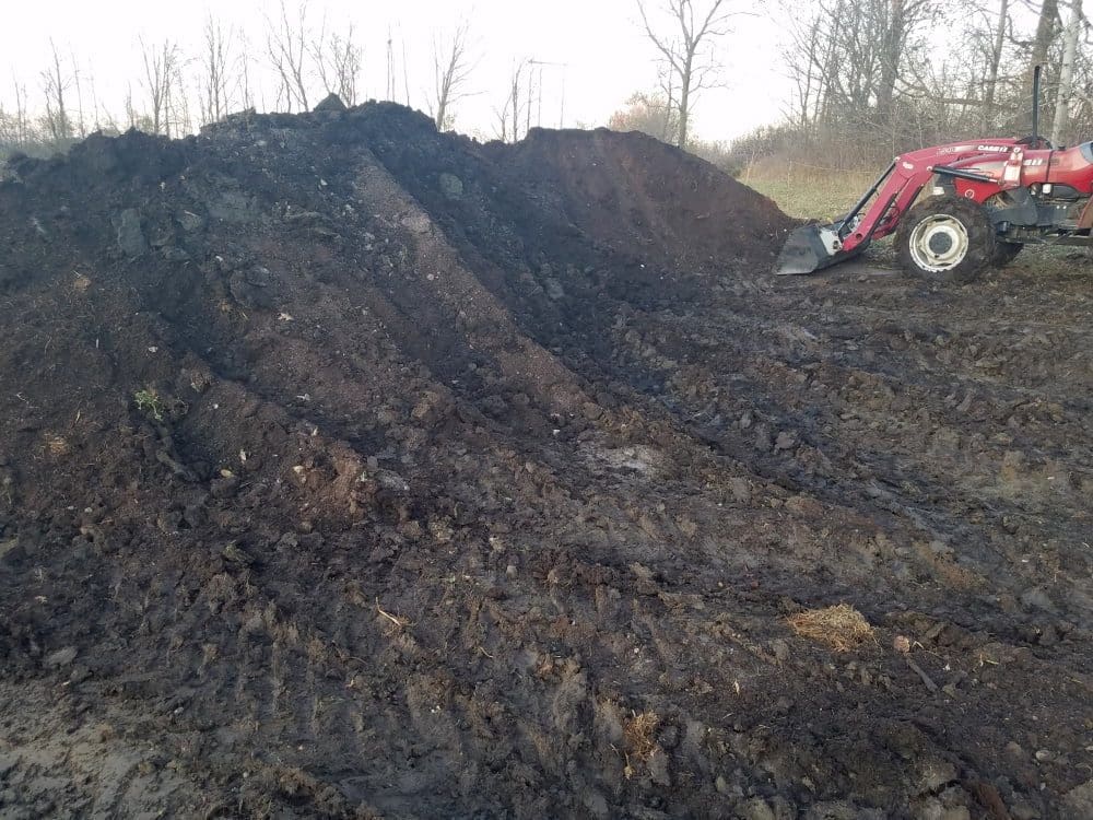 Large pile of compost on our pasture raised chicken farm.  Compost is a critical part of regenerative, organic farming.