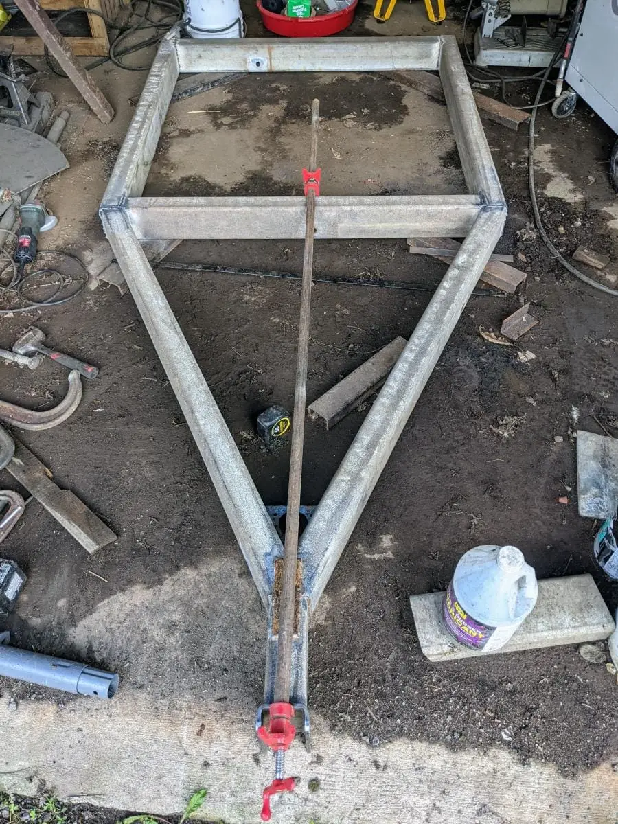 Welding chicken feeder trailer in the shop.