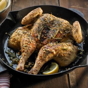 A Certified Organic and Pasture Raised chicken from Wrong Direction Farm, cooked in a spatchcock style in a cast iron pan.