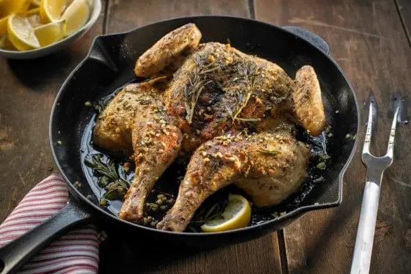 A Certified Organic and Pasture Raised chicken from Wrong Direction Farm, cooked in a spatchcock style in a cast iron pan.