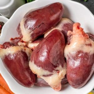 Pasture Raised, Certified Organic Turkey Hearts in a Bowl with Carrots, Garlic, and Spices.