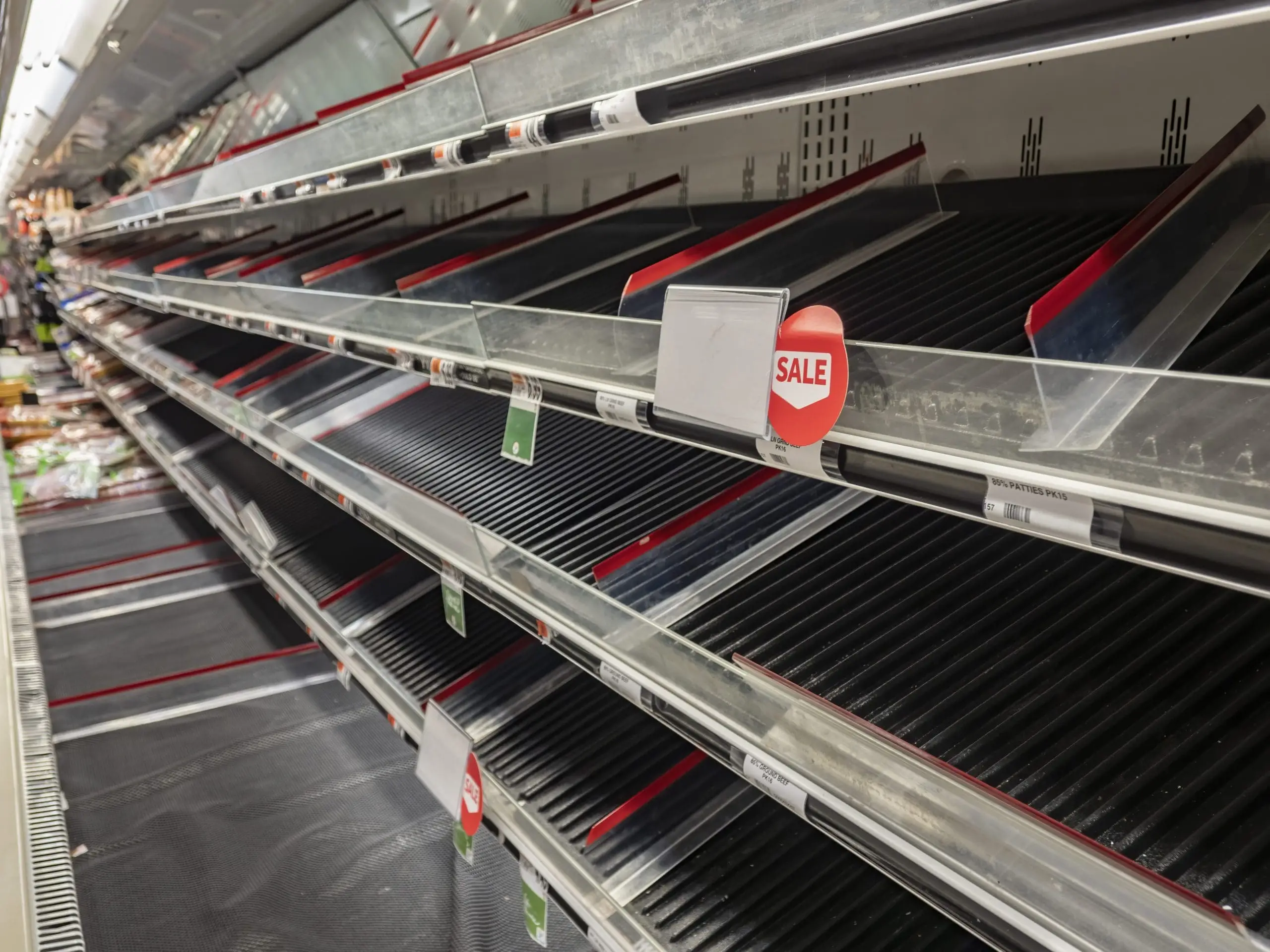 Empty meat isle at supermarket after virus outbreak causes panic and people panic buy produce,.