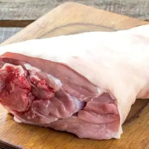 Pasture raised pork hock on cutting board.