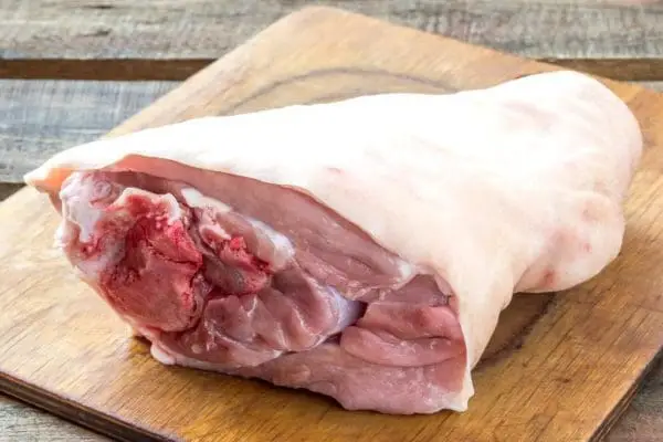 Pasture raised pork hock on cutting board.