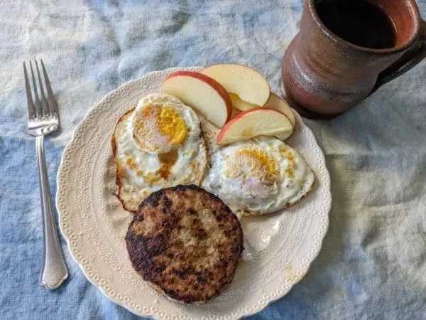 Pasture raised turkey breakfast sausage patty with eggs on a plate in the kitchen at Wrong Direction Farm