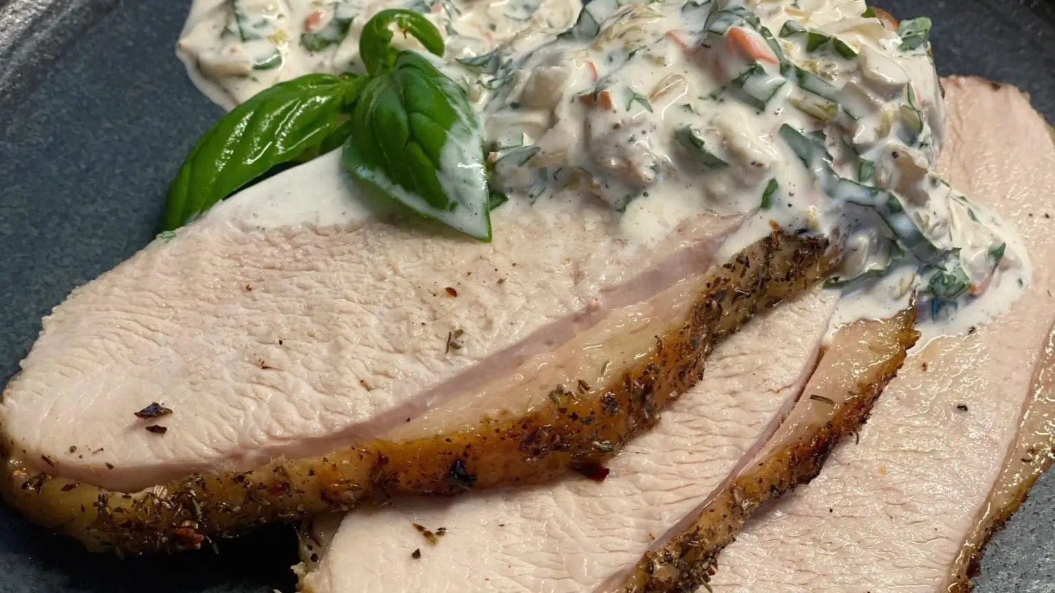 Pasture raised turkey breast recipe shown sliced on a platter.